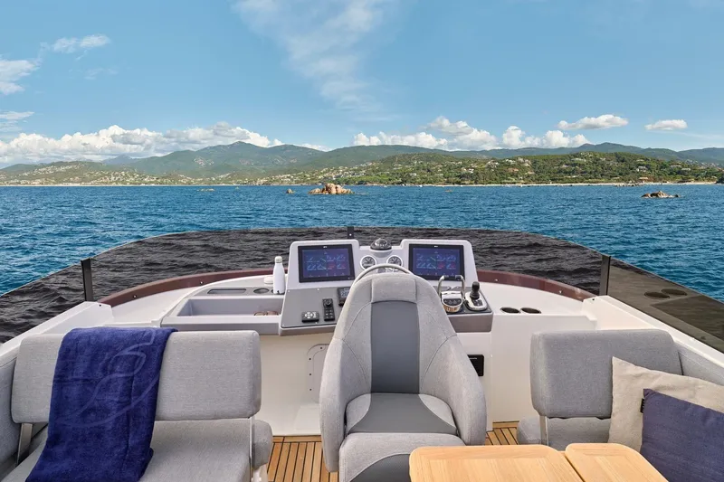 Slide: The Image of 2026 Beneteau Swift Trawler 48 helm with scenic ocean and mountain view. - 14