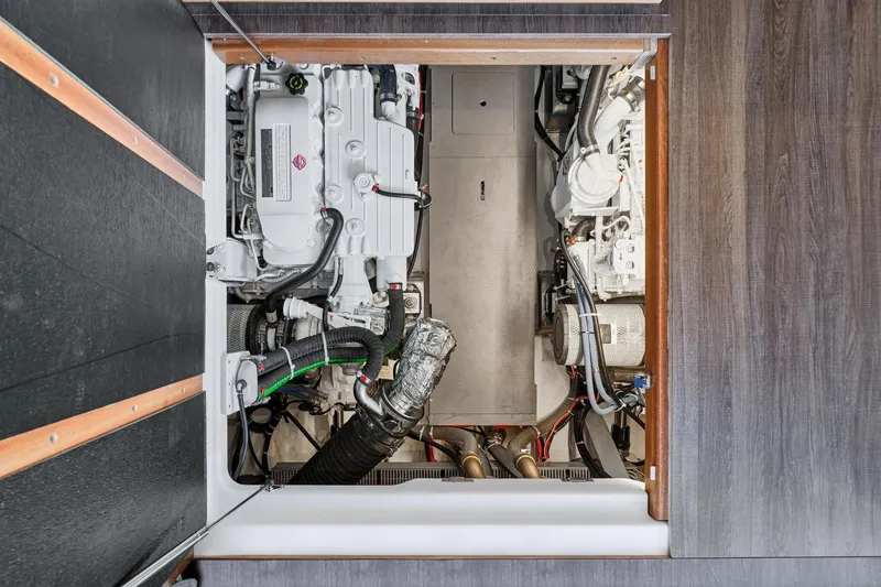 Slide: The Image of Engine room of 2026 Beneteau Swift Trawler 48, showcasing dual engines and mechanical components. - 22