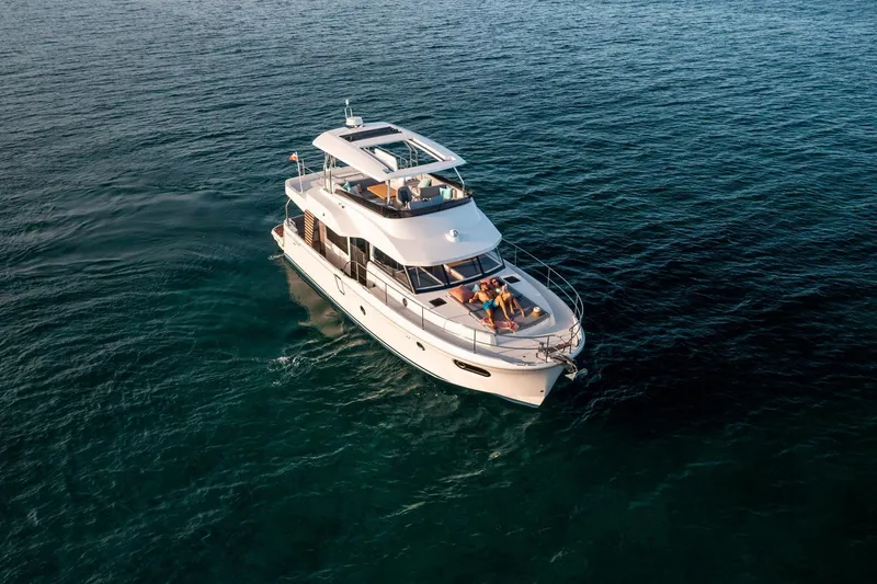 Slide: The Image of 2026 Beneteau Swift Trawler 48 cruising on open water, aerial view. - 23