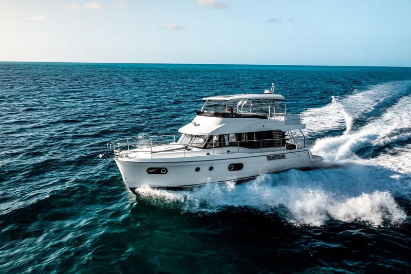 Slide: The Image of 2026 Beneteau Swift Trawler 48 cruising on open ocean waters. - 24