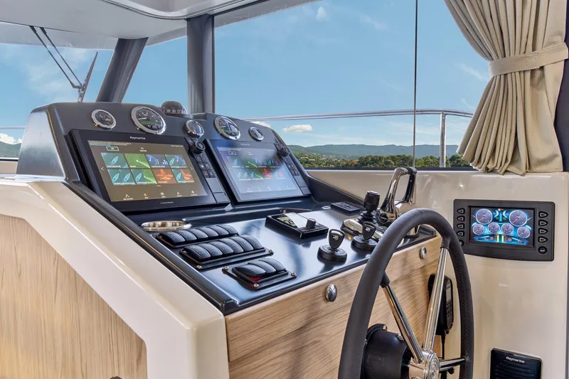 Slide: The Image of 2026 Beneteau Swift Trawler 48 helm with advanced navigation displays and controls. - 4