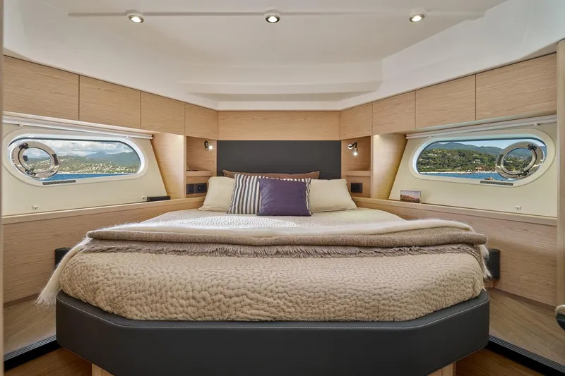 Slide: The Image of Luxurious bedroom interior of 2026 Beneteau Swift Trawler 48 with scenic window views. - 8