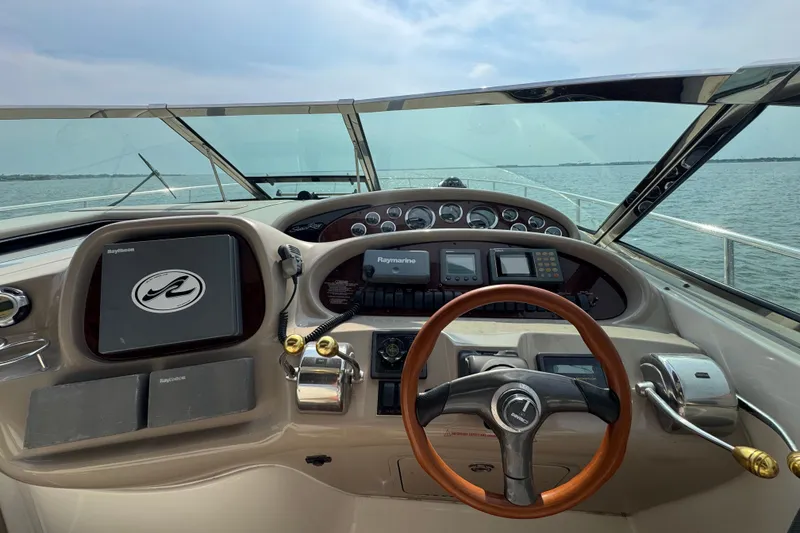 Slide: The Image of Cockpit view of 2000 Sea Ray 380 Sundancer yacht with steering wheel and navigation instruments. - 13
