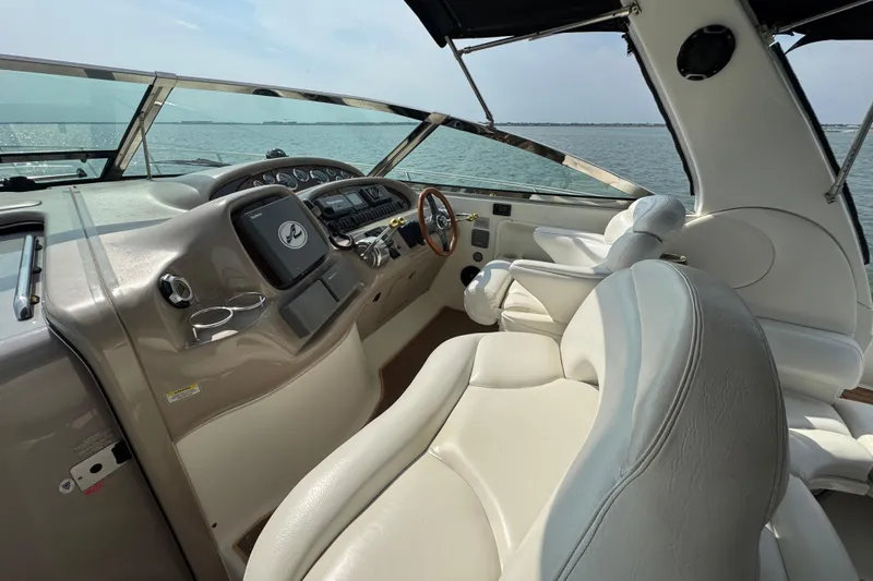 Slide: The Image of Interior view of 2000 Sea Ray 380 Sundancer yacht cockpit with leather seating and ocean backdrop. - 14