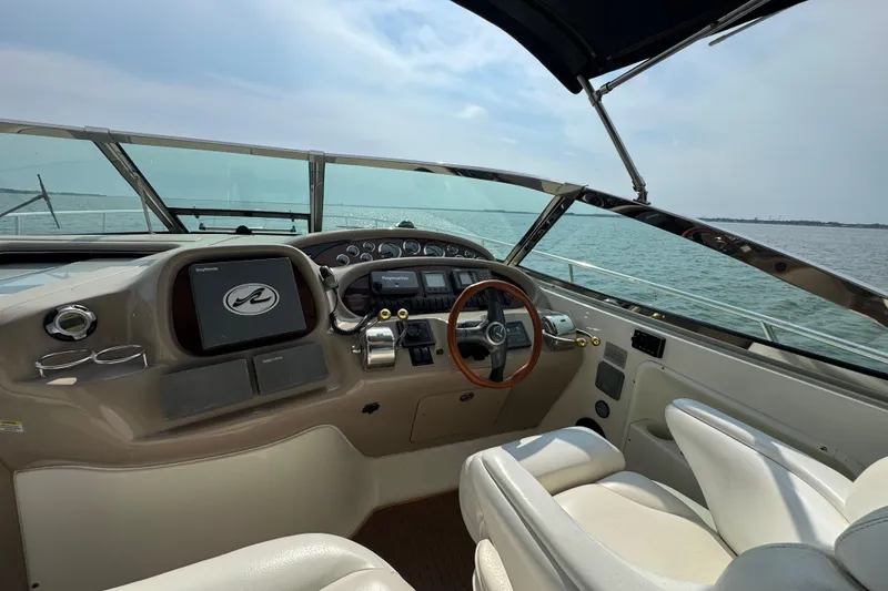 Slide: The Image of Cockpit of 2000 Sea Ray 380 Sundancer yacht with steering wheel and navigation controls. - 15