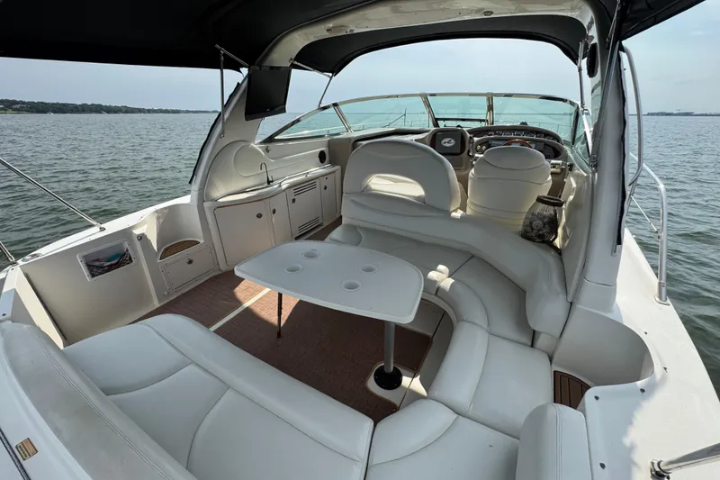 Slide: The Image of Luxurious 2000 Sea Ray 380 Sundancer yacht interior with white seating and table on open water. - 21