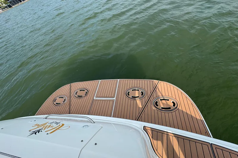 Slide: The Image of Rear deck of 2000 Sea Ray 380 Sundancer overlooking calm water. - 23