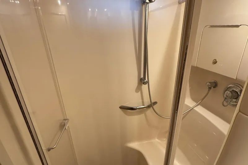 Slide: The Image of Shower area inside a 2000 Sea Ray 380 Sundancer yacht, featuring a handheld showerhead. - 28