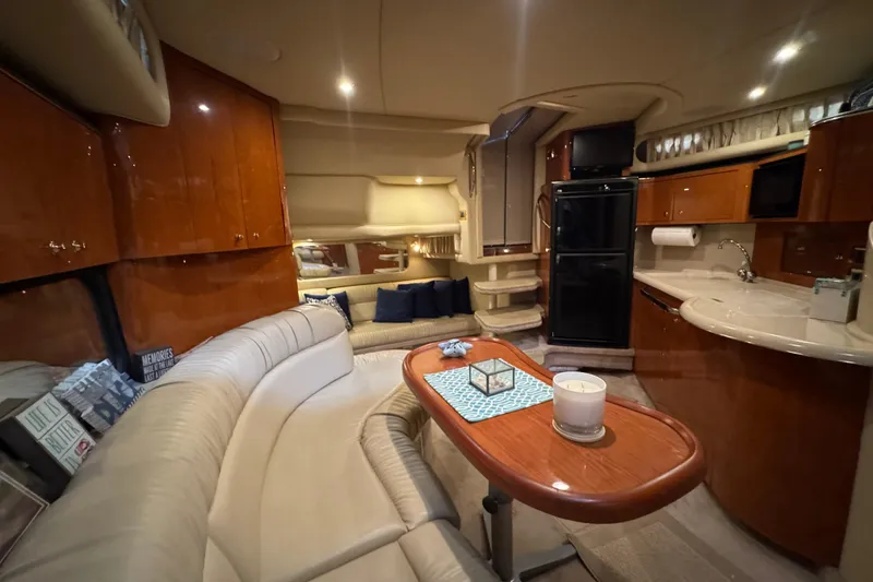 Slide: The Image of Luxurious interior of 2000 Sea Ray 380 Sundancer yacht with elegant seating and kitchenette. - 30