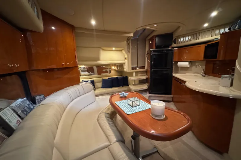 Slide: The Image of Luxurious interior of a 2000 Sea Ray 380 Sundancer yacht with elegant seating and kitchenette. - 31