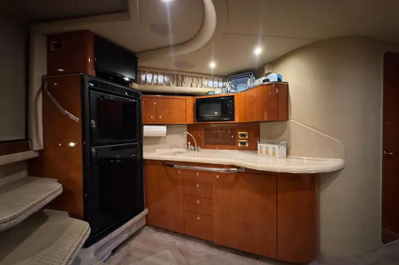Slide: The Image of Luxurious kitchen interior of 2000 Sea Ray 380 Sundancer yacht with modern amenities. - 33