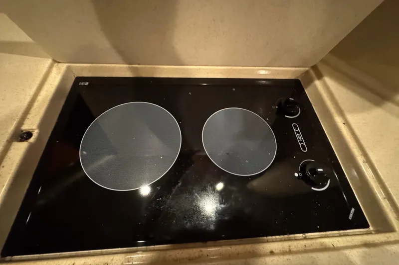 Slide: The Image of Stovetop in 2000 Sea Ray 380 Sundancer yacht kitchen, featuring dual burners. - 34