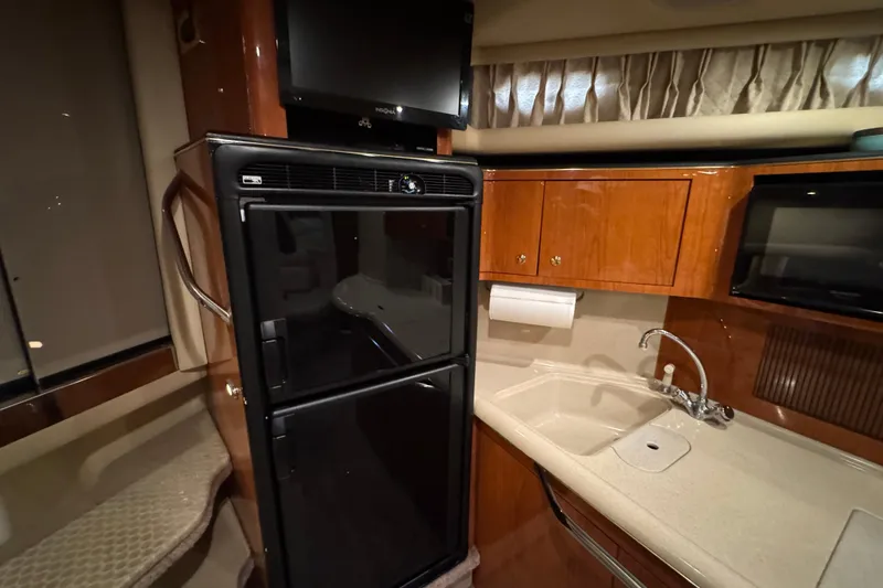 Slide: The Image of Interior of 2000 Sea Ray 380 Sundancer yacht with kitchenette and appliances. - 37