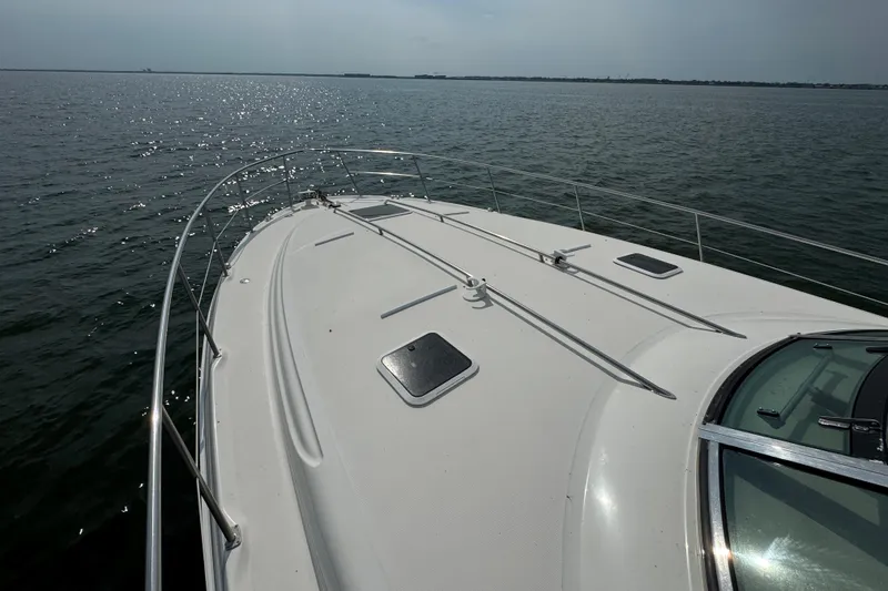 Slide: The Image of Bow view of 2000 Sea Ray 380 Sundancer yacht on calm waters. - 9