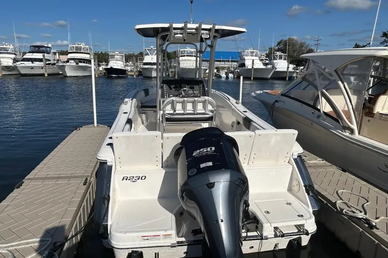 Slide: The Image of 2020 Robalo R230 Center Console boat with open storage compartment and seating. - 12