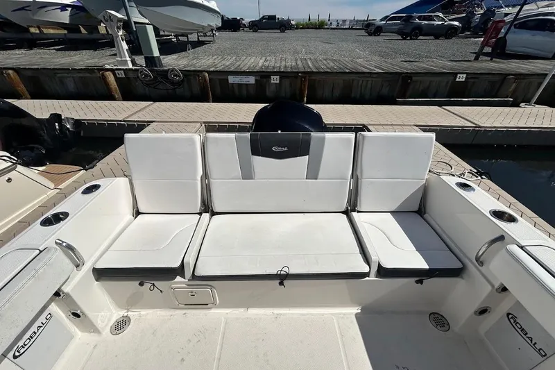 Slide: The Image of 2020 Robalo R230 Center Console boat docked at marina, rear view. - 6