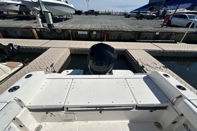 Slide: The Image of 2020 Robalo R230 Center Console boat interior at marina, surrounded by yachts. - 7