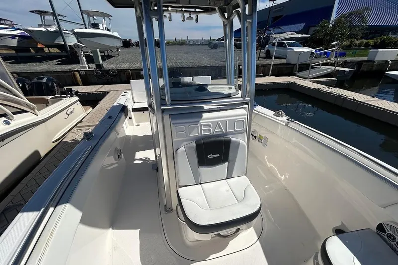 Slide: The Image of 2020 Robalo R230 Center Console boat with open storage compartment at dock. - 9