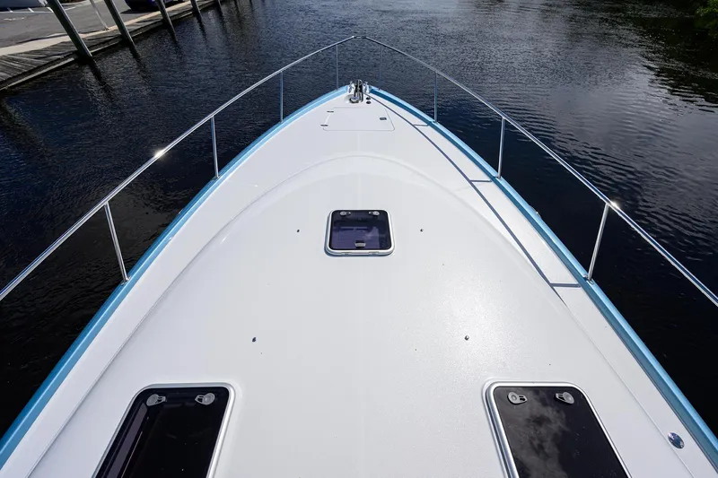 Slide: The Image of 2024 Palm Beach Motor Yachts GT50 bow view on calm water. - 29