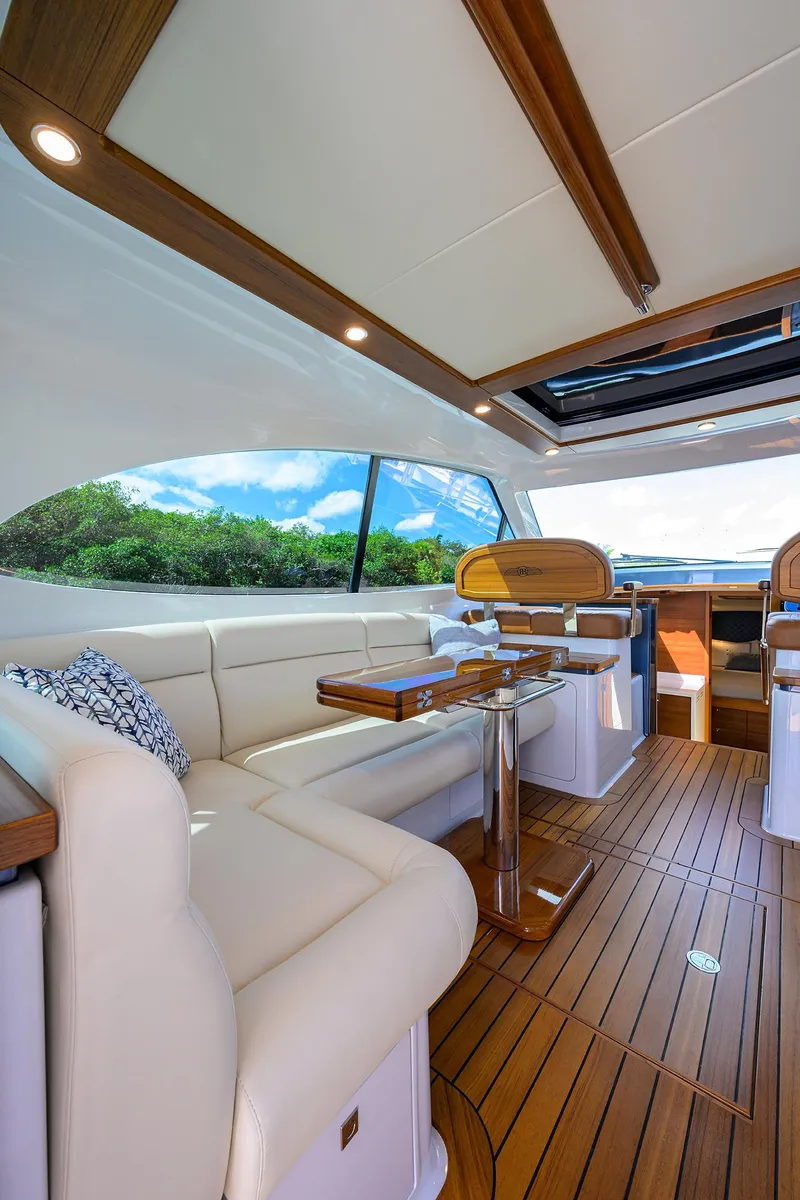Slide: The Image of 2024 Palm Beach Motor Yachts GT50 interior with elegant seating and wooden flooring. - 35