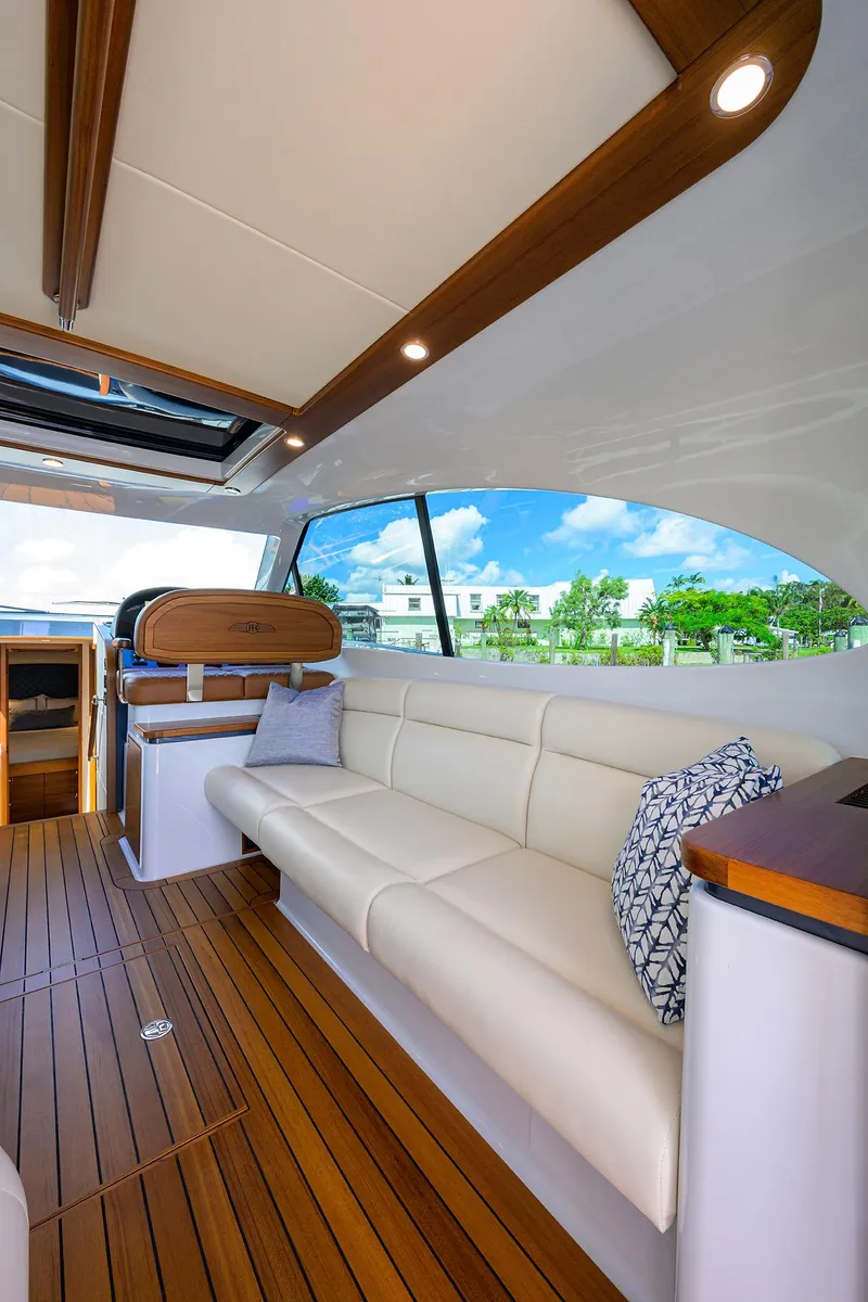 Slide: The Image of 2024 Palm Beach Motor Yachts GT50 interior with elegant seating and wooden flooring. - 42