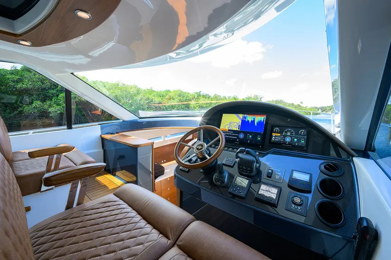Slide: The Image of 2024 Palm Beach Motor Yachts GT50 helm with luxurious interior and advanced navigation system. - 47