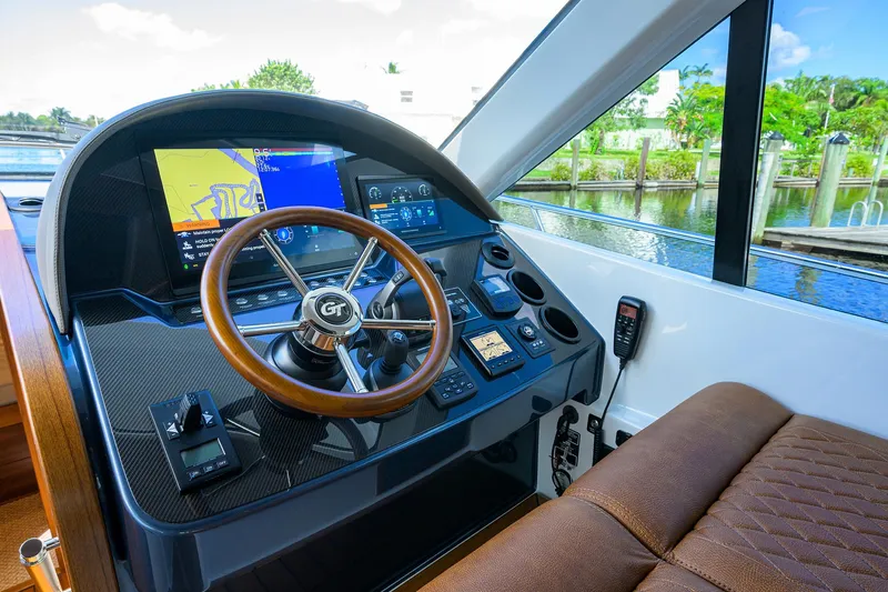 Slide: The Image of 2024 Palm Beach Motor Yachts GT50 helm with advanced navigation system and luxurious seating. - 48
