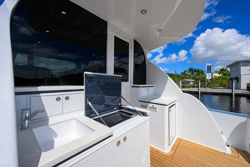 Slide: The Image of 2024 Palm Beach Motor Yachts GT50 deck with modern amenities and sleek design. - 22