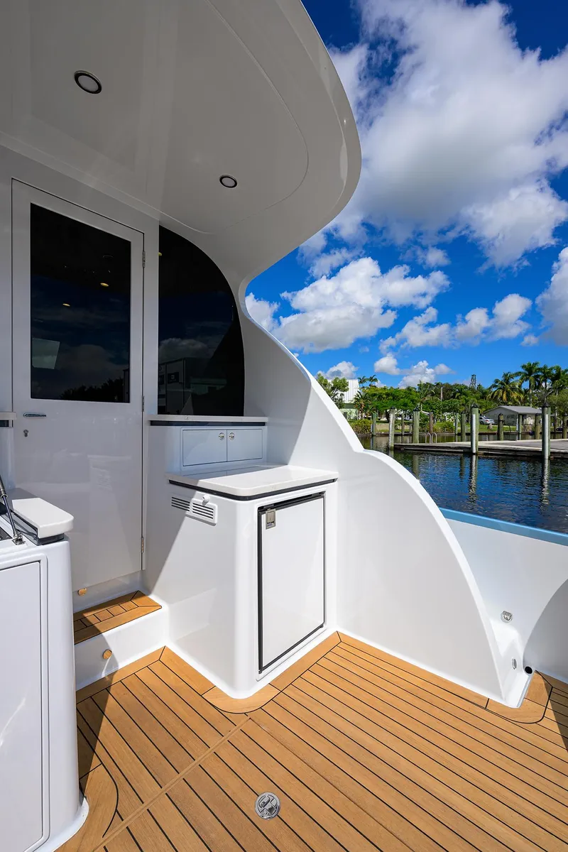 Slide: The Image of 2024 Palm Beach Motor Yachts GT50 deck with sleek design and scenic waterfront view. - 23