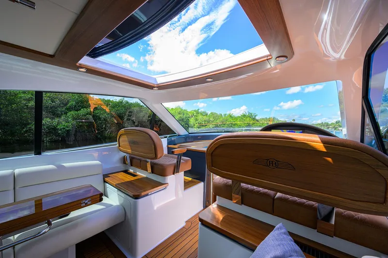 Slide: The Image of Luxurious interior of 2024 Palm Beach Motor Yachts GT50 with panoramic sunroof and elegant wood finishes. - 45