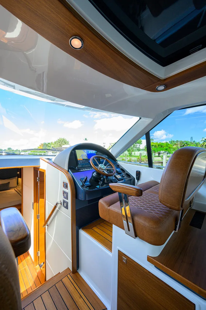 Slide: The Image of 2024 Palm Beach Motor Yachts GT50 interior with luxurious helm and panoramic views. - 49