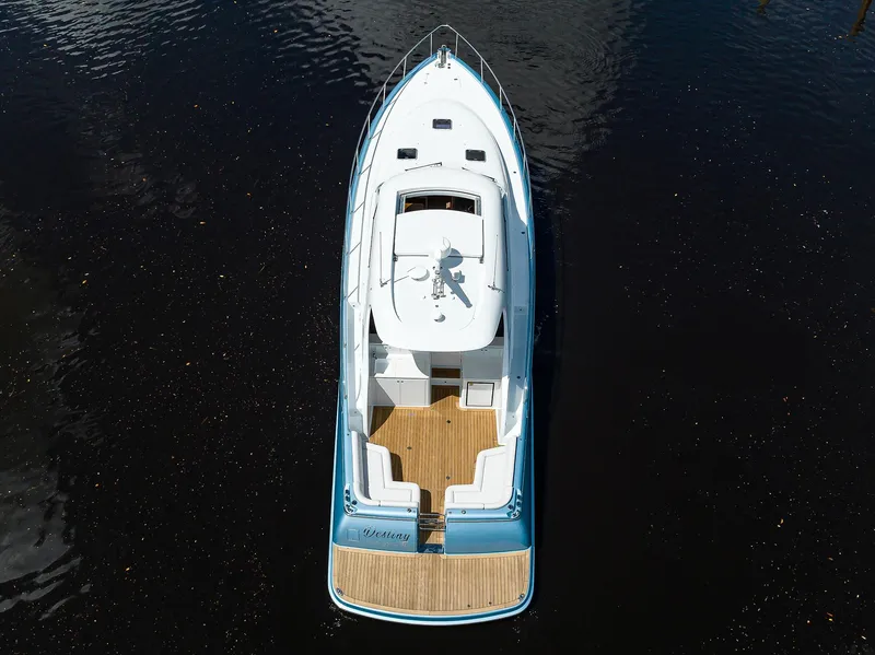 Slide: The Image of 2024 Palm Beach Motor Yachts GT50, aerial view, sleek design, wooden deck, cruising on water. - 7