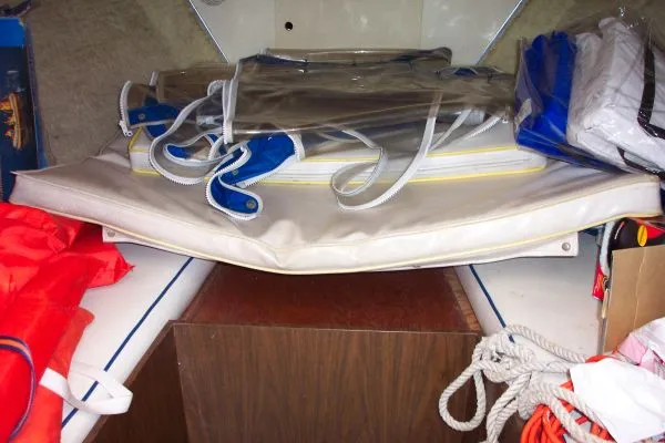 Slide: The Image of 1979 Bertram Flybridge Cruiser interior with stored boating equipment and ropes. - 10