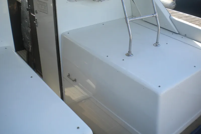 Slide: The Image of 1979 Bertram Flybridge Cruiser deck with metal railing and cabin entrance. - 15