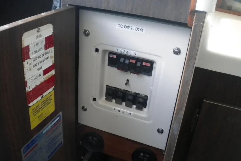 Slide: The Image of Electrical panel on a 1979 Bertram Flybridge Cruiser, labeled "DC DIST. BOX." - 17