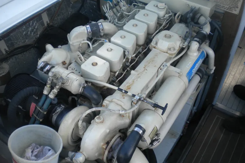 Slide: The Image of 1979 Bertram Flybridge Cruiser engine, showcasing detailed mechanical components and piping. - 20