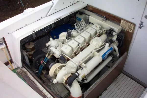 Slide: The Image of 1979 Bertram Flybridge Cruiser engine compartment, showcasing a well-maintained marine engine. - 25