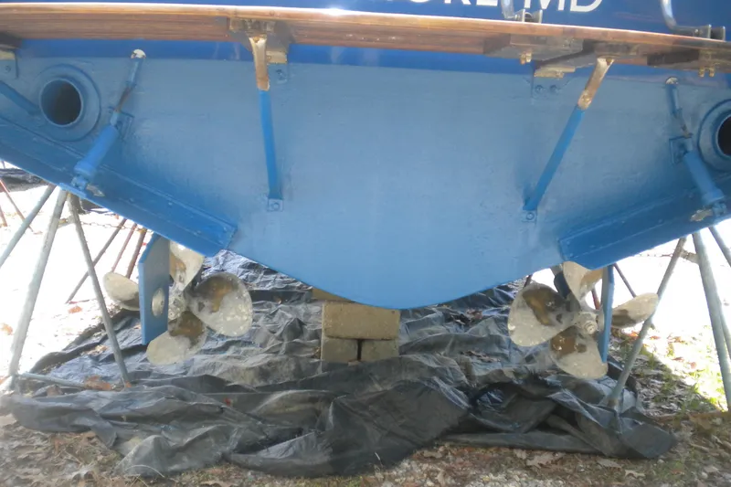 Slide: The Image of Stern view of a 1979 Bertram 31 Flybridge Cruiser with dual propellers. - 27