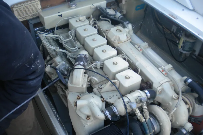 Slide: The Image of Engine of a 1979 Bertram Flybridge Cruiser, showcasing detailed mechanical components. - 23