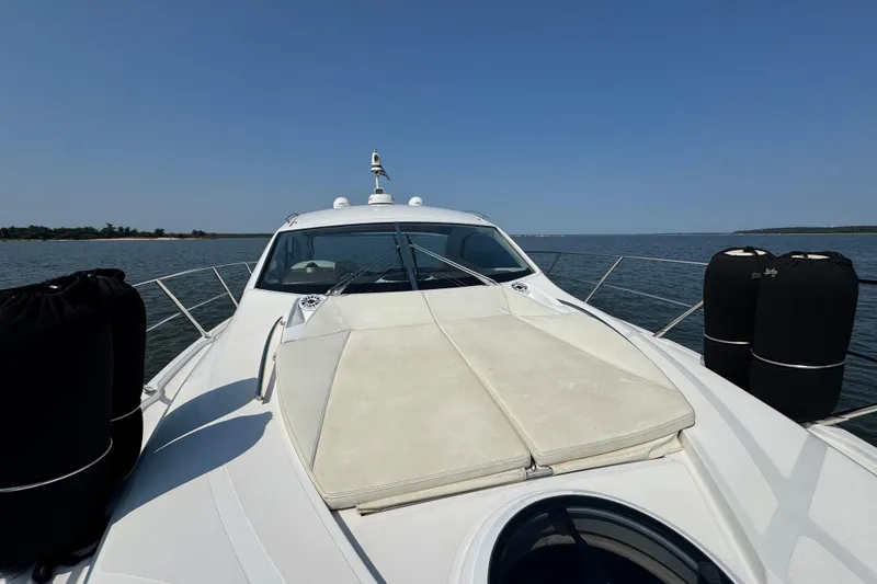 Slide: The Image of 2013 Sessa Marine C44 Cruiser on calm water, featuring spacious deck and sleek design. - 11