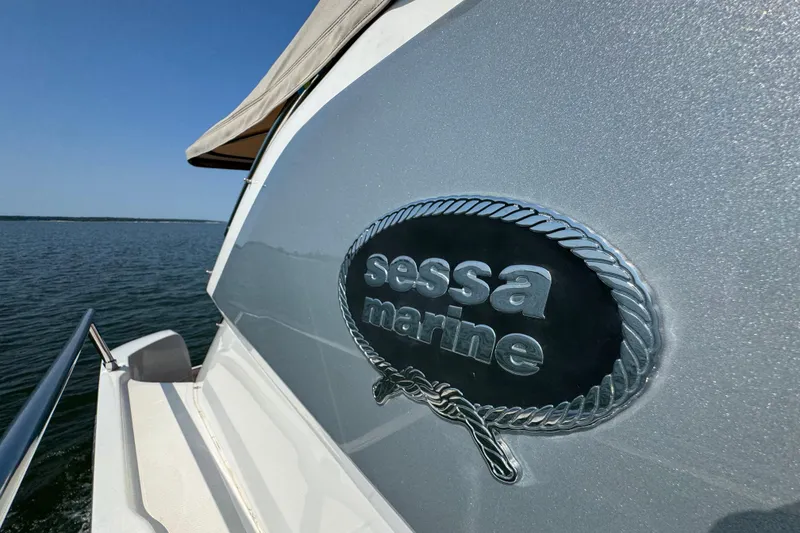 Slide: The Image of 2013 Sessa Marine C44 Cruiser on open water, showcasing brand emblem. - 12