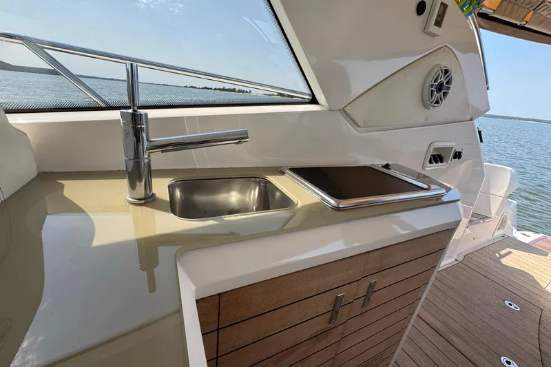 Slide: The Image of 2013 Sessa Marine C44 Cruiser yacht kitchen with sink and stovetop, overlooking the water. - 19