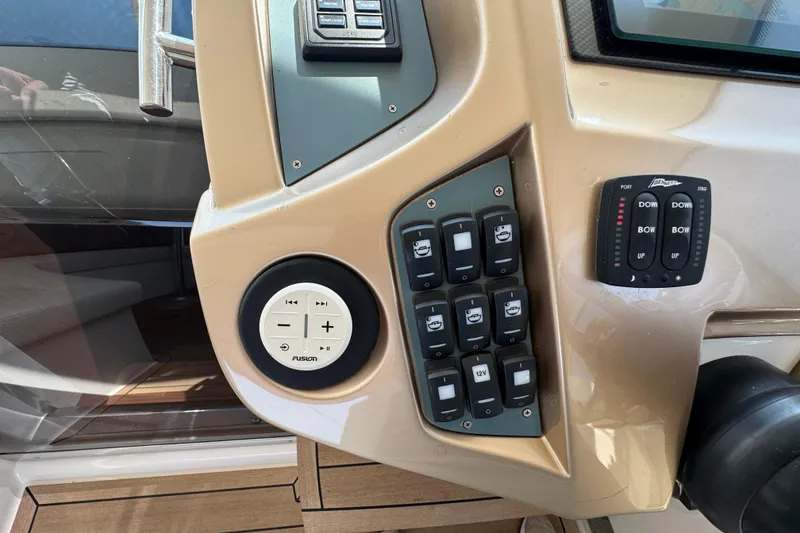 Slide: The Image of Control panel of 2013 Sessa Marine C44 Cruiser with switches and Fusion audio controls. - 32