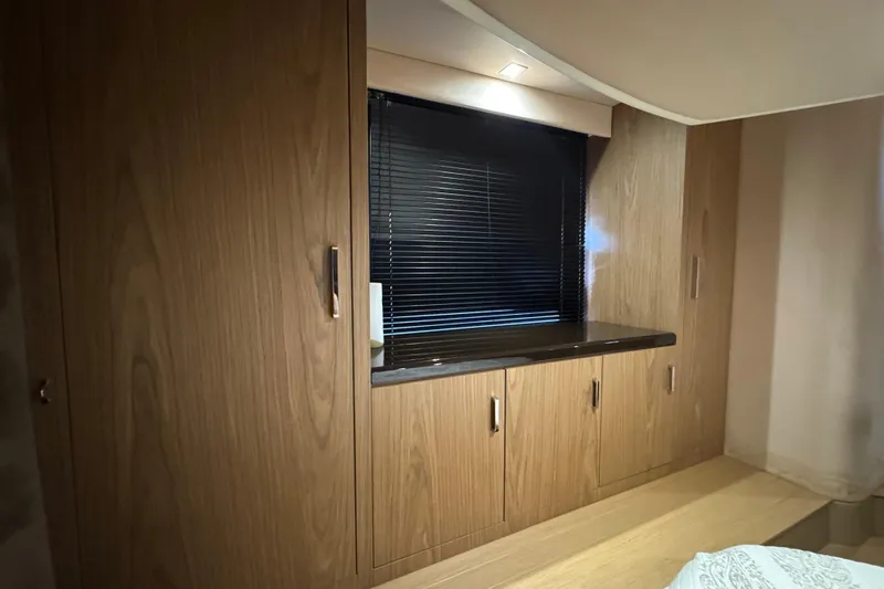 Slide: The Image of Interior of 2013 Sessa Marine C44 Cruiser with wooden cabinetry and window blinds. - 36
