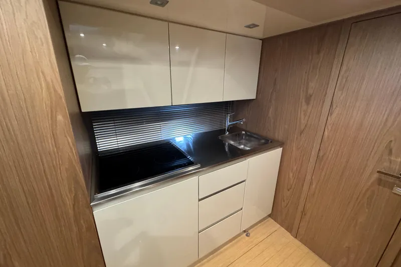 Slide: The Image of Modern kitchen in 2013 Sessa Marine C44 Cruiser with sleek cabinetry and stainless steel sink. - 42