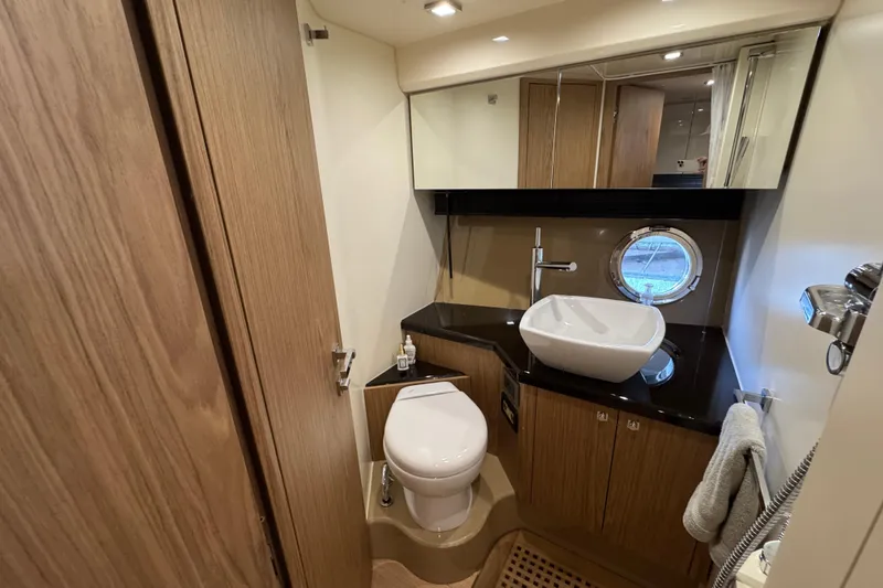 Slide: The Image of Luxurious bathroom in 2013 Sessa Marine C44 Cruiser with modern fixtures and porthole window. - 43