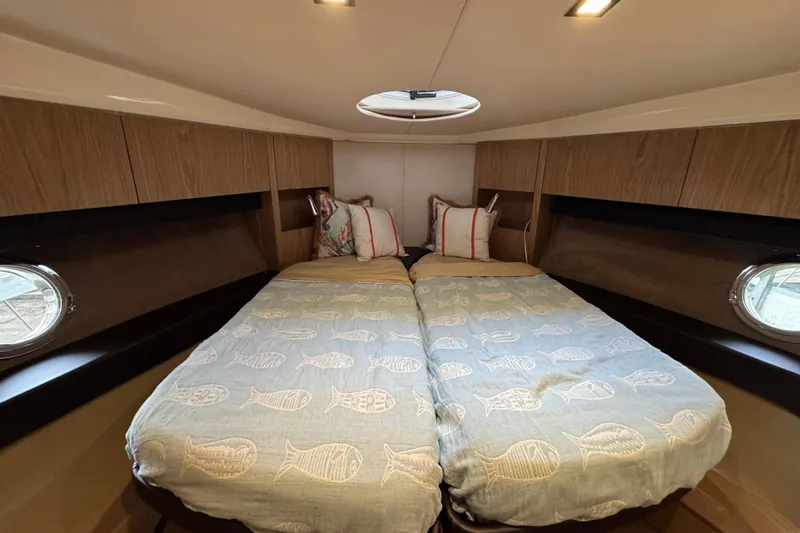 Slide: The Image of Interior cabin of 2013 Sessa Marine C44 Cruiser with twin beds and portholes. - 44