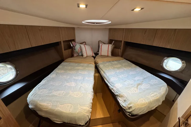 Slide: The Image of Cabin interior of 2013 Sessa Marine C44 Cruiser with twin beds and portholes. - 45