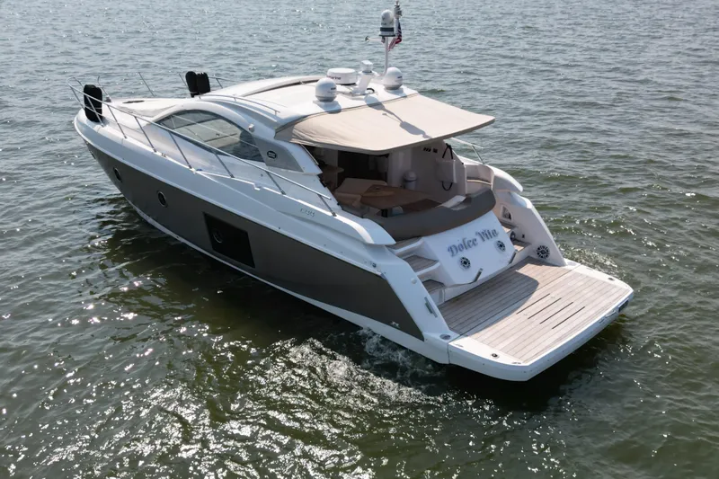 Slide: The Image of 2013 Sessa Marine C44 Cruiser on open water, showcasing sleek design and spacious deck. - 7
