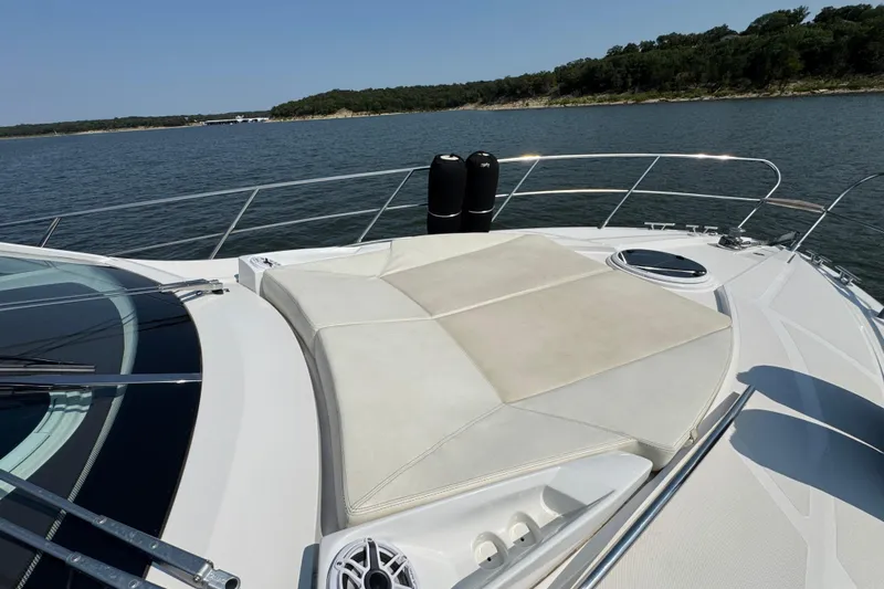 Slide: The Image of 2013 Sessa Marine C44 Cruiser on serene water, featuring spacious sunbathing deck. - 9